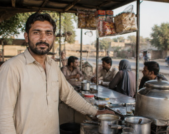 Pakistani man operating a small tea stall business, generating sustainable income to support his family and escape poverty