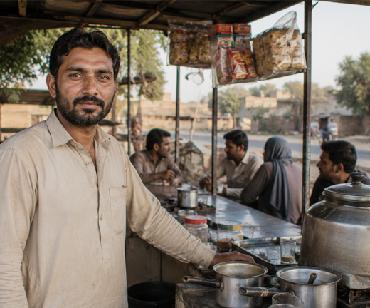 Pakistani man operating a small tea stall business, generating sustainable income to support his family and escape poverty