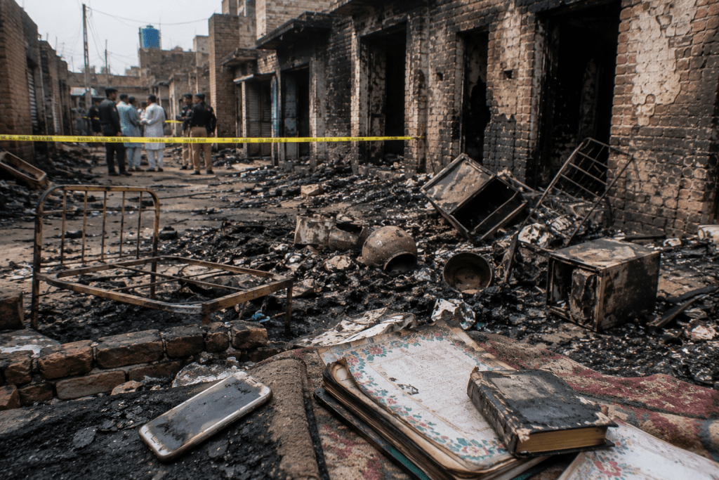 Burned homes symbolizing the 2014 Gujranwala attack on Ahmadi families